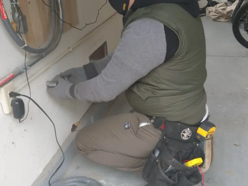 Electrician performing outlet wiring in a Palo Alto garage